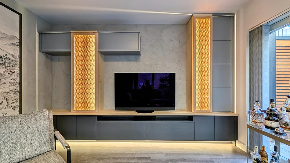 Backlit kumiko cabinet doors set within a contemporary grey residential wall