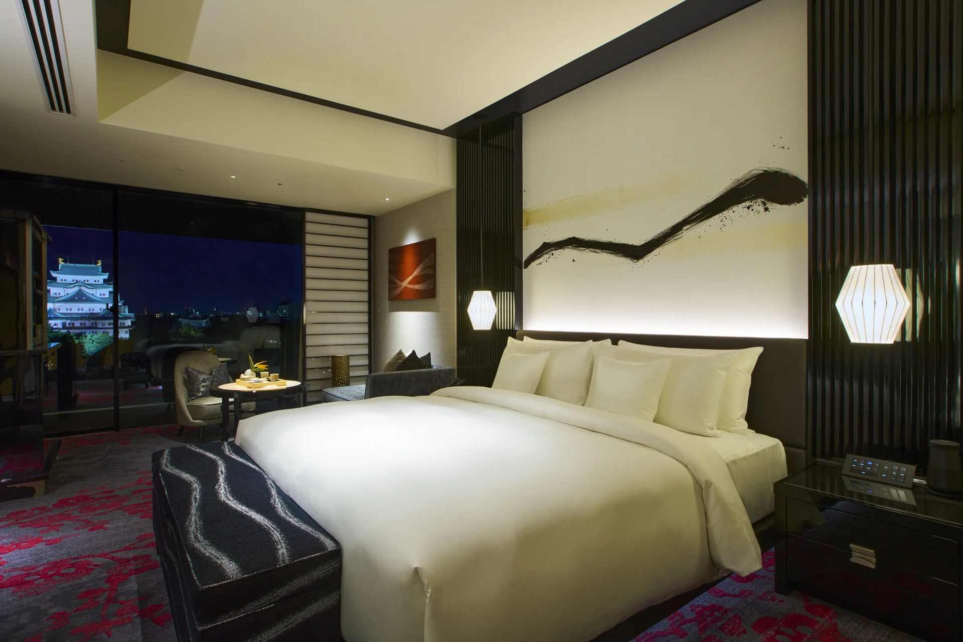 Sweeping washi artwork across a pale wall above a bed in an ESPACIO Nagoya Castle guest room