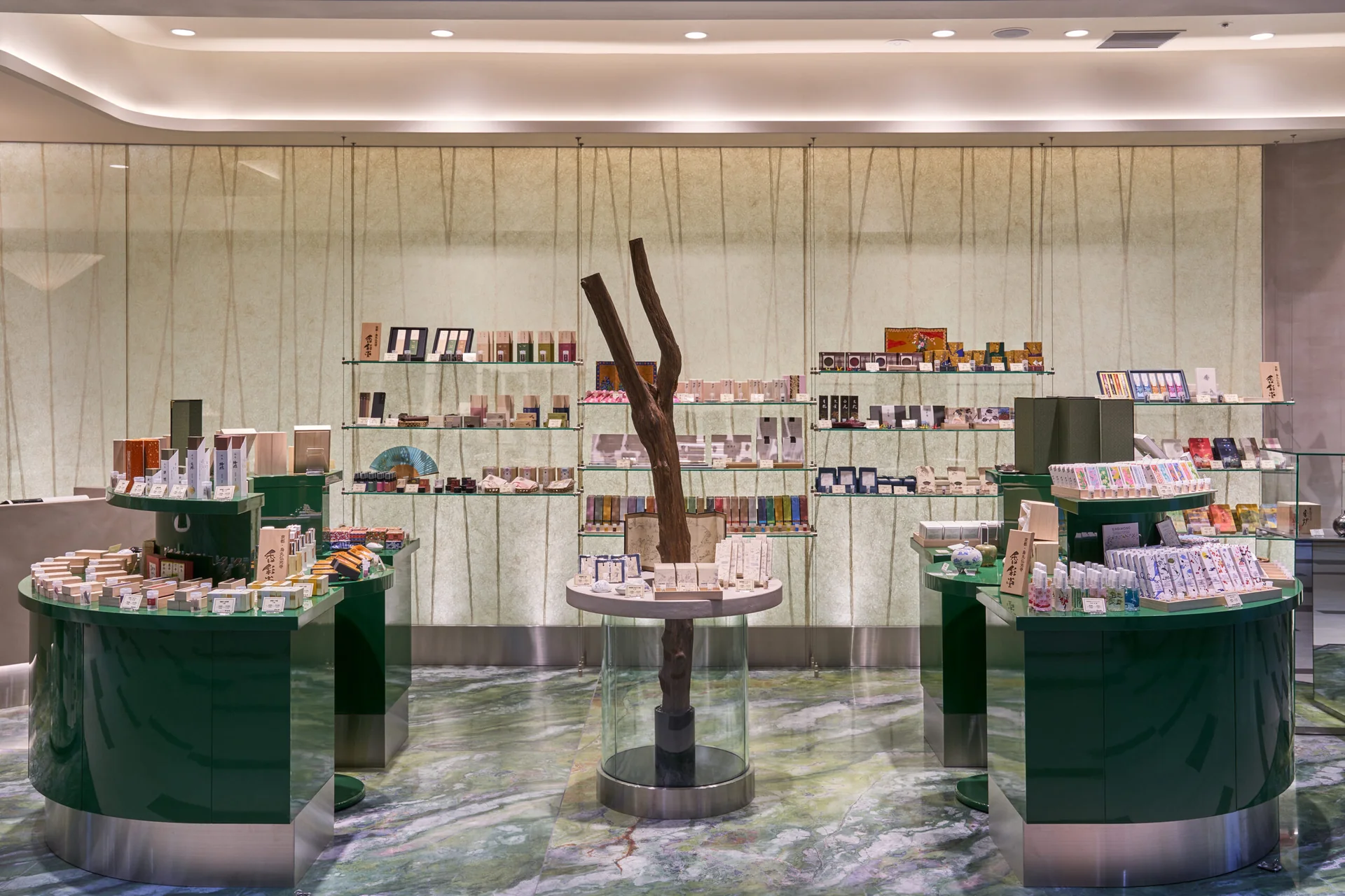 Pale textured paper wall behind curved retail displays at Kosaido in Narita Airport
