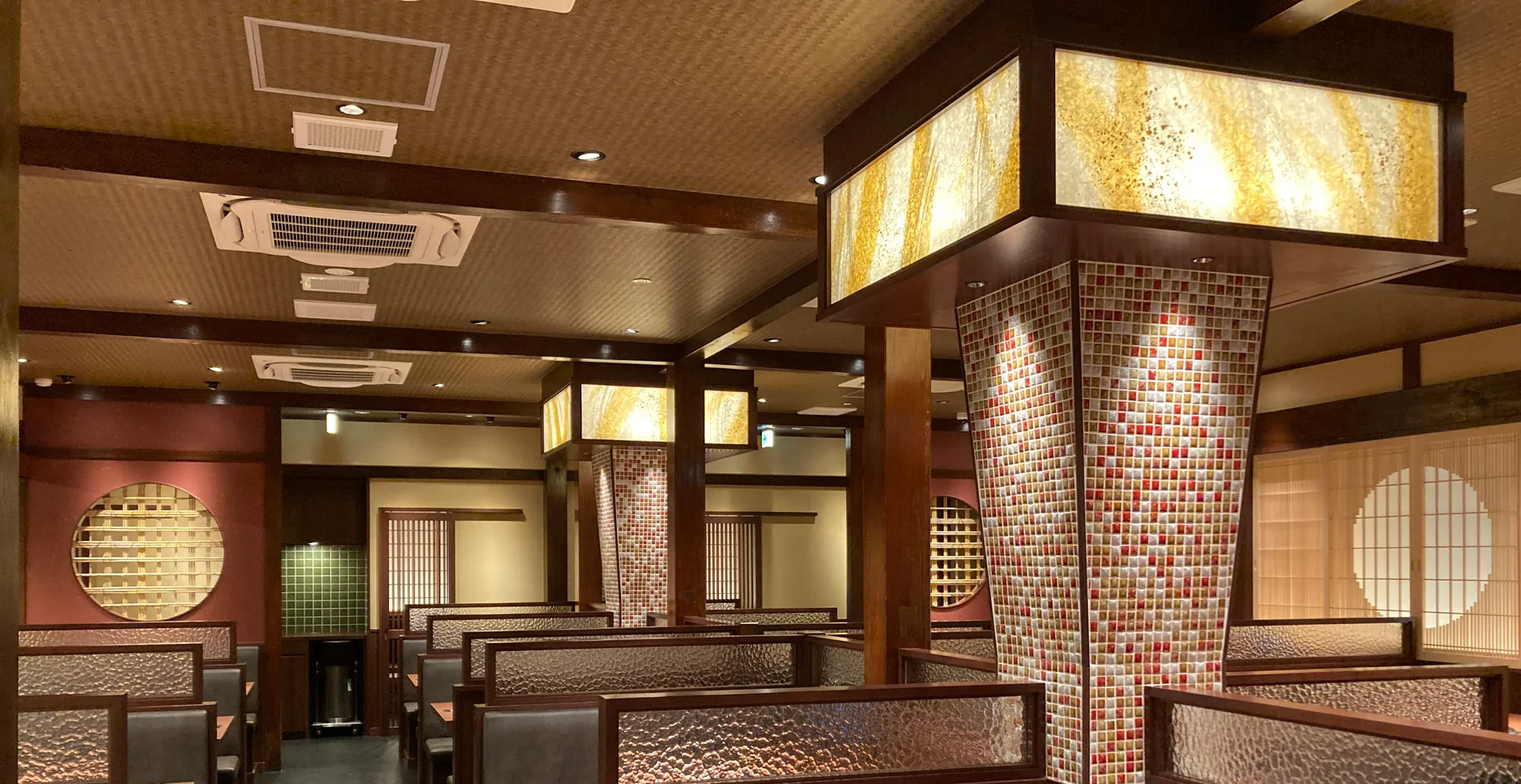 Glowing paper light panels above booths in a Japanese restaurant